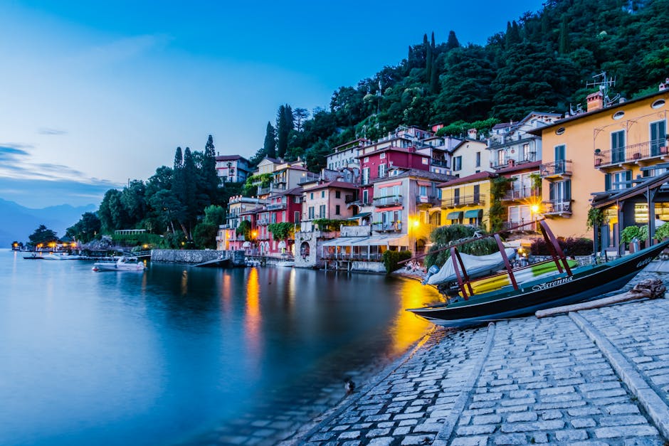 Charming lakeside view of colorful houses in Como, Italy at twilight.