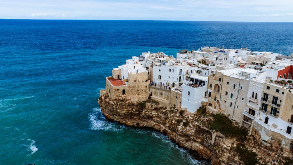 Scenic aerial view of Polignano a Mare's historic clifftop town by the Mediterranean Sea.