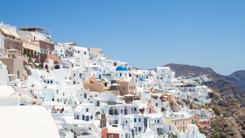 A captivating view of Santorini's iconic white buildings under a clear blue sky.